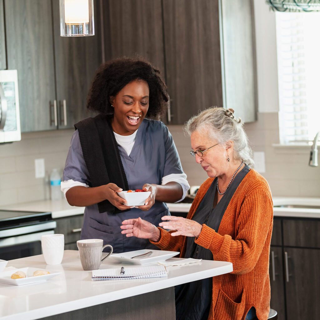 Caretaker helping woman with a meal