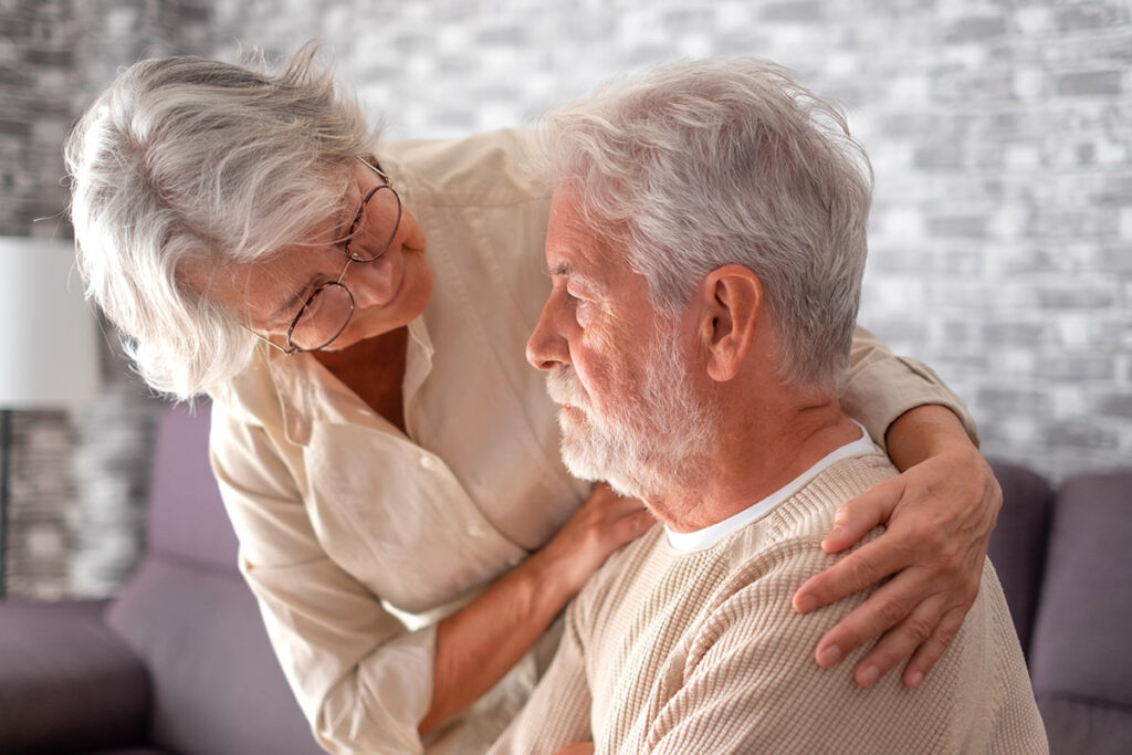 Wife comforting husband with Alzheimers