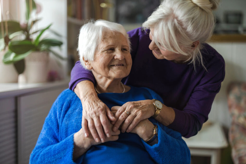 Caretaker with arm around client