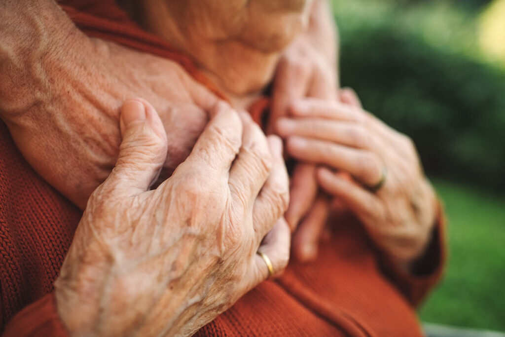 Hands on shoulder of Lewy Body Dementia patient