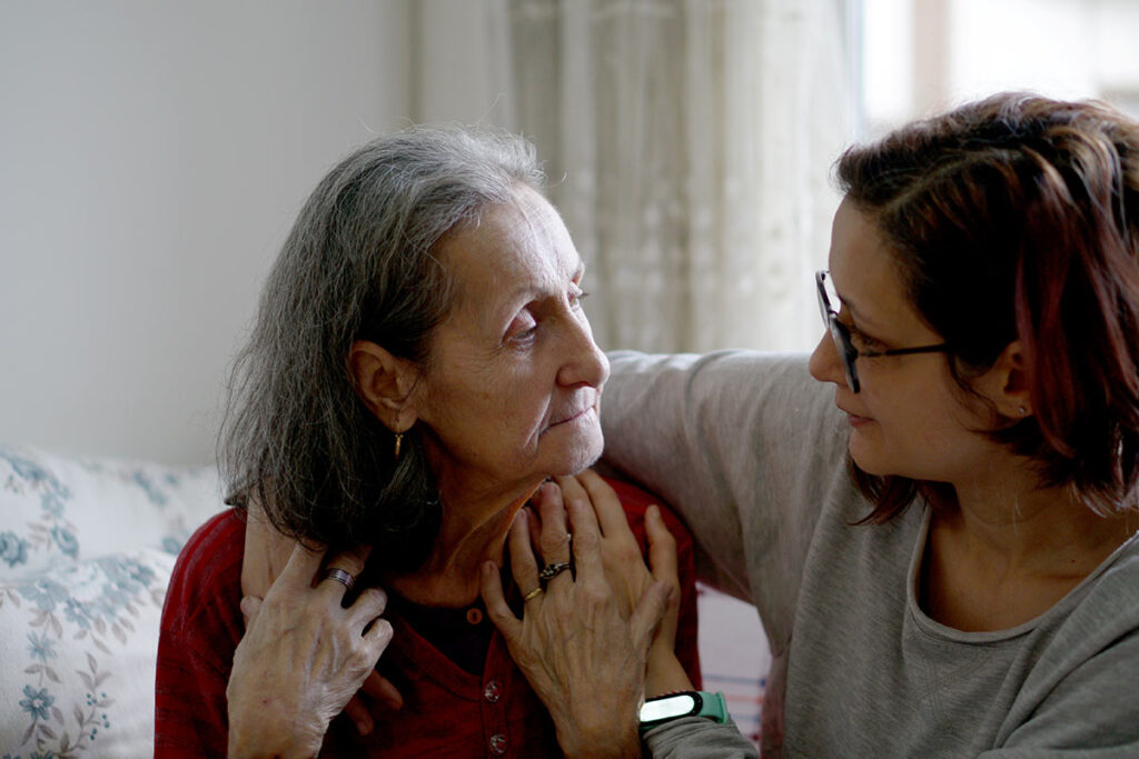 Caretaker with arm around client