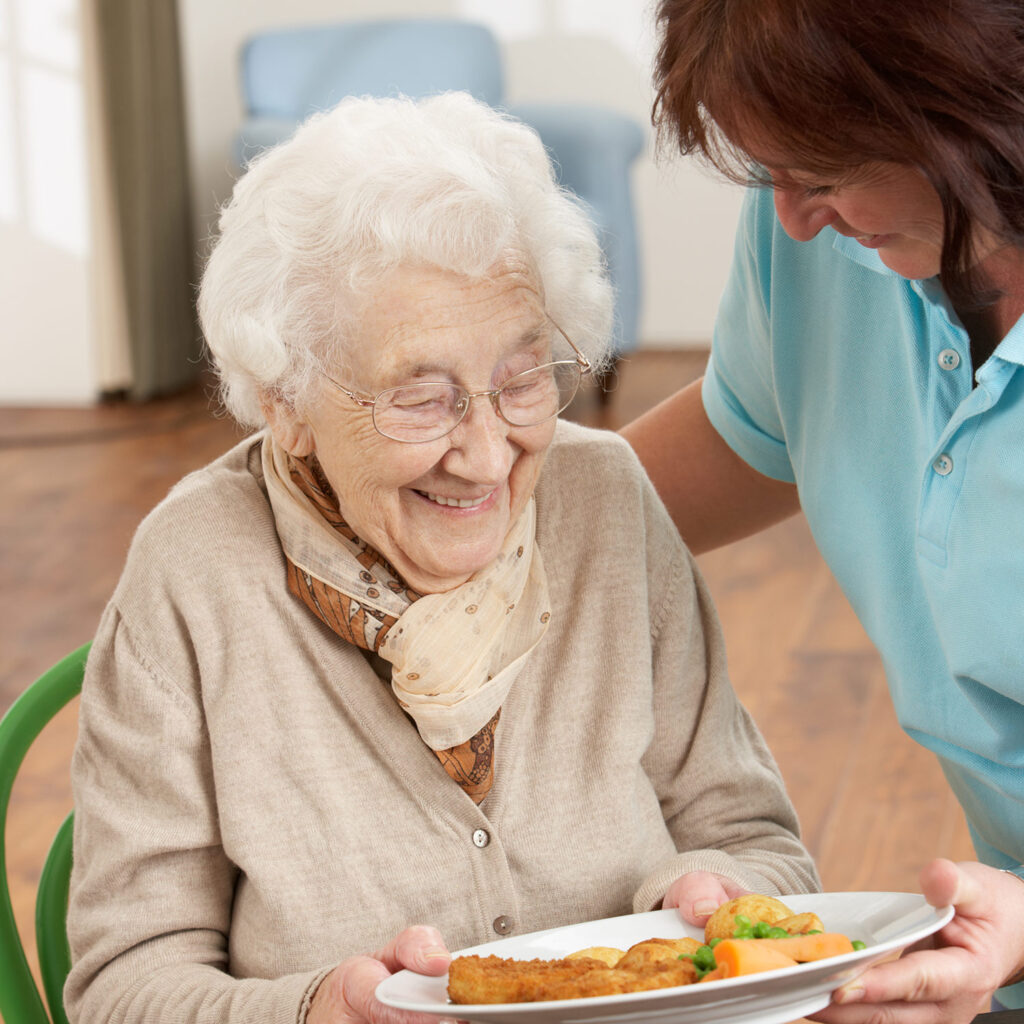 Caretaker helping with food